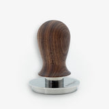 Wiedemann Wiedecent Tamper V6 Nussbaum 58.35mm with ergonomic design and stainless steel base for precise espresso tamping.