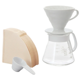 Hario V60 Ceramic Dripper Set 02 in white with filters and glass carafe.